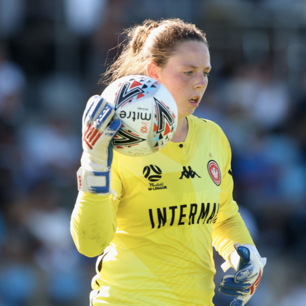 Western Sydney Wanderers goalkeeper bouncing a ball with Tee3 goalkeeping gloves on during a game