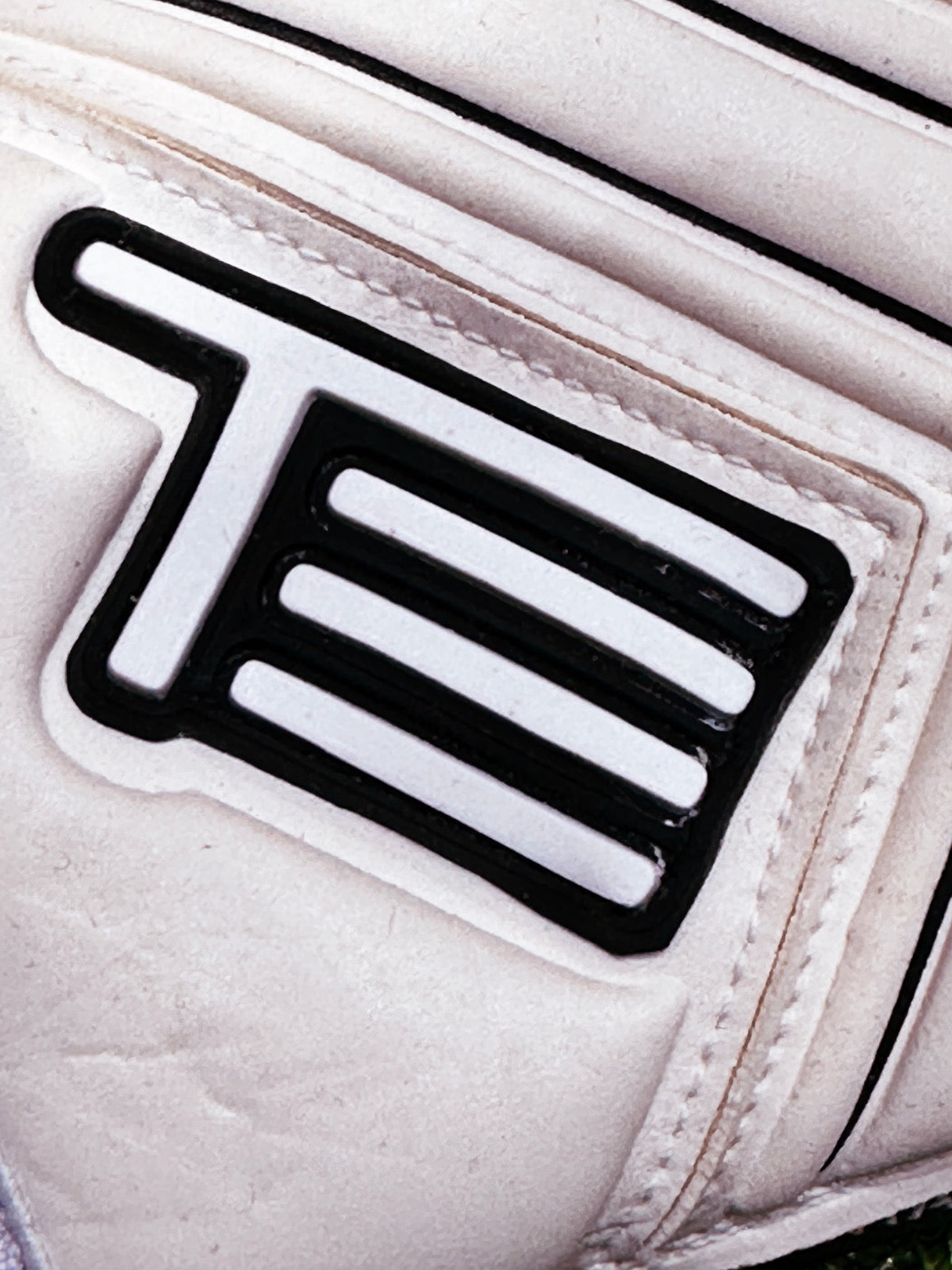 A white roll finger goalkeeping glove with a double wrap strap and 4mm German contact latex worn by professional goalkeepers