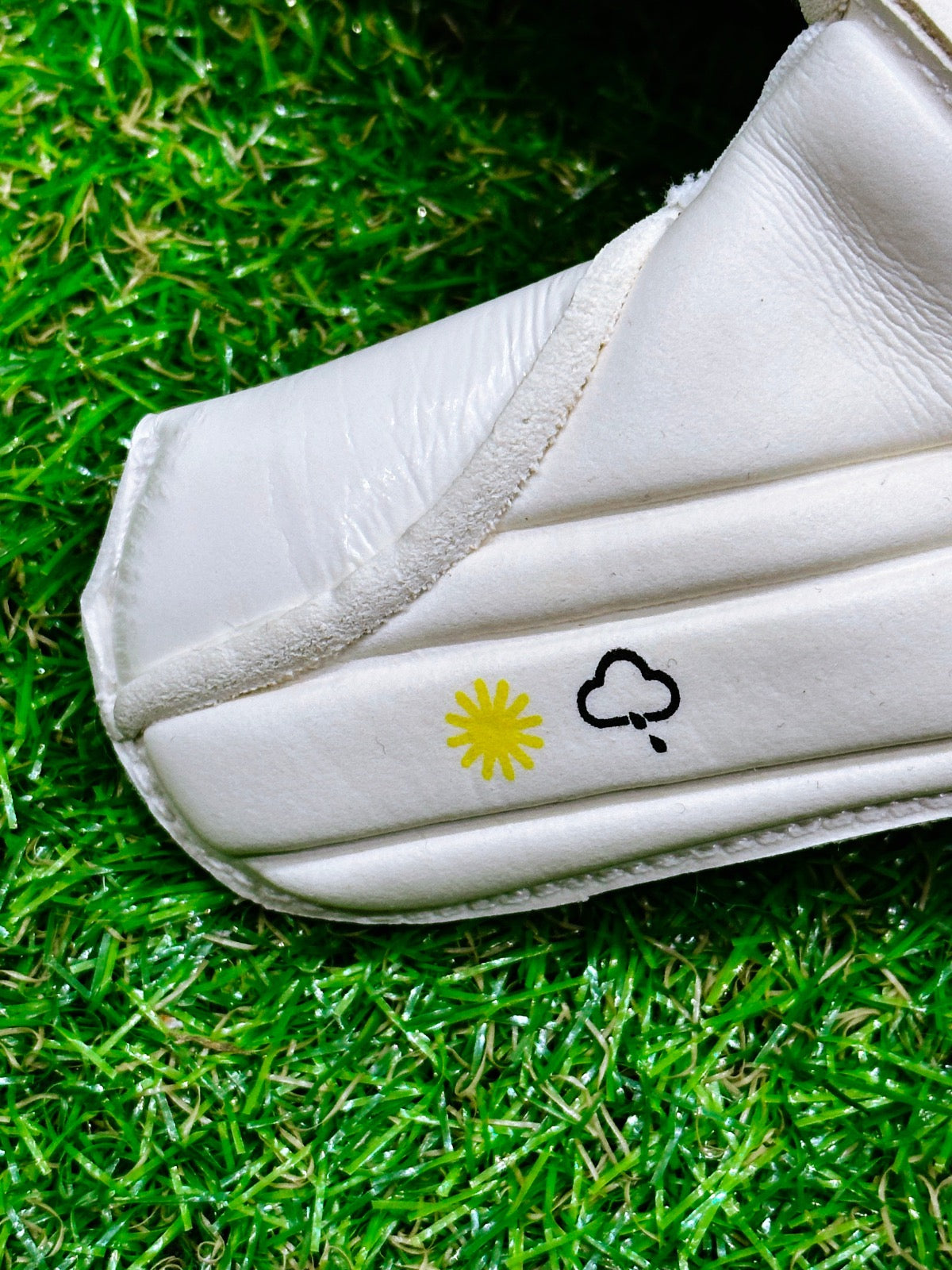 A white roll finger goalkeeping glove with a double wrap strap and 4mm German contact latex worn by professional goalkeepers