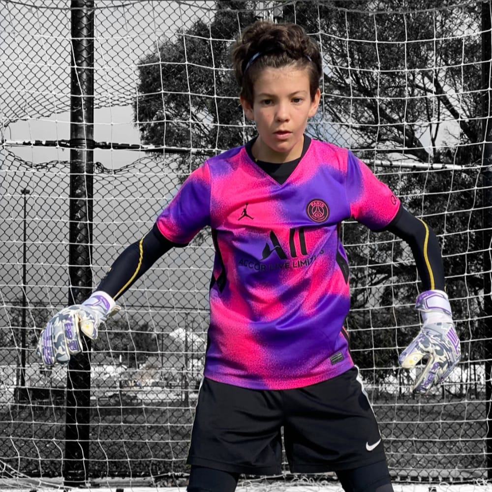 Young goalkeeper concentrating on catching